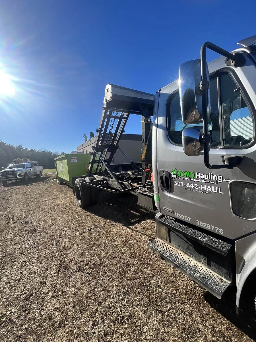 SOMD Hauling roll-off dumpster truck on a demolition and debris removal job